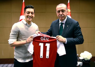 FILE - In this file photo taken on Sunday, May 13, 2018, Turkey's President Recep Tayyip Erdogan, right, poses for a photo with Arsenal soccer player Mesut Ozil in London. Germany midfielder Ozil has announced his retirement from international soccer, alleging racial discrimination. (Presidential Press Service/Pool via AP, File)