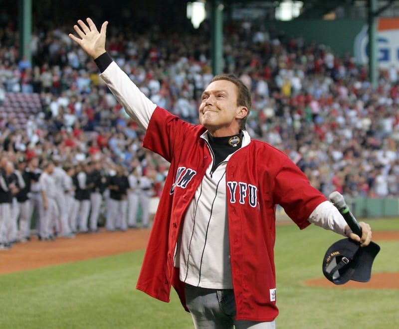 David Cassidy reacts to the crowd after singing the national anthem before a baseball game between the Boston Red Sox and Chicago White Sox at Fenway Park in Boston. AP