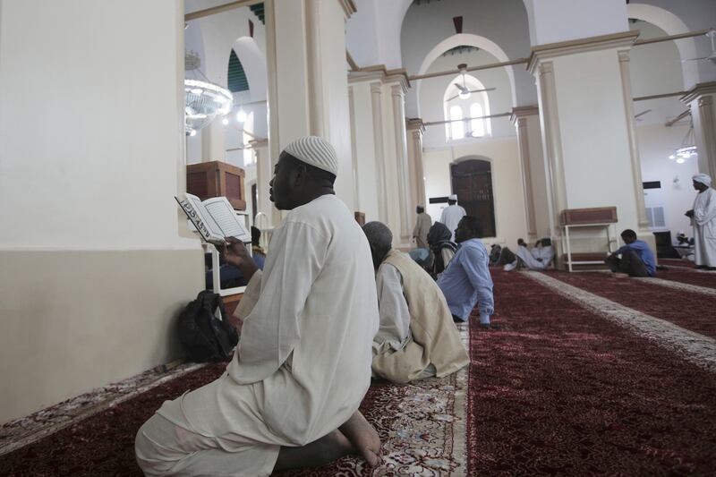 Men pray at the Grand Mosque, Khartoum. AP