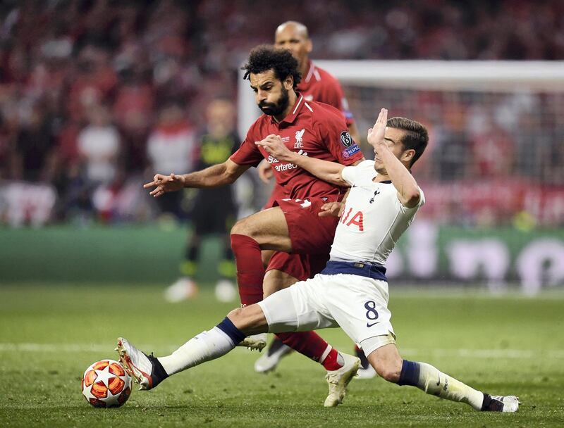 MADRID, SPAIN - JUNE 01: Harry Winks of Tottenham Hotspur slides in to tackle Mohamed Salah of Liverpool during the UEFA Champions League Final between Tottenham Hotspur and Liverpool at Estadio Wanda Metropolitano on June 01, 2019 in Madrid, Spain. (Photo by Matthias Hangst/Getty Images)