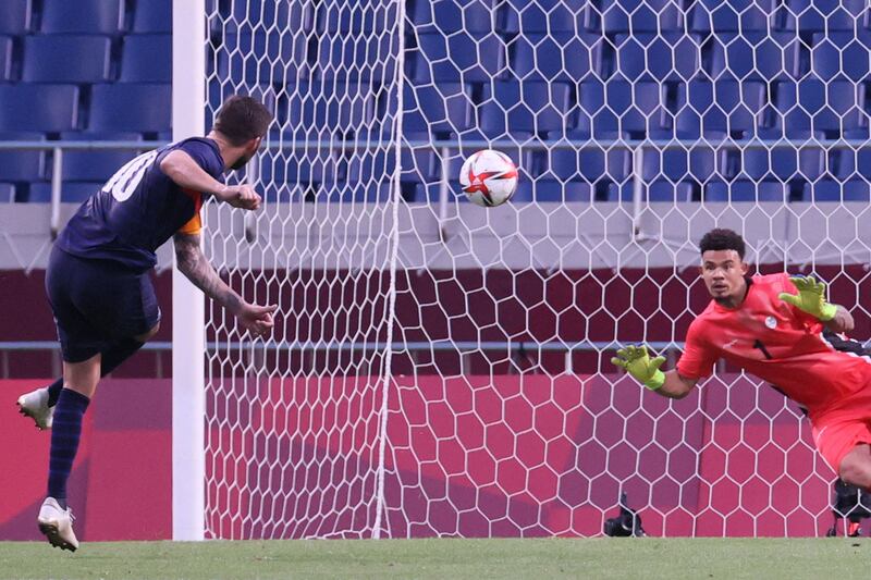 France forward Andre-Pierre Gignac scores a penalty past South Africa's goalkeeper Ronwen Williams.