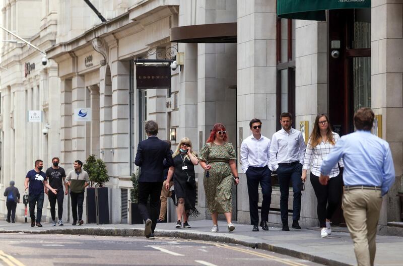 Workers pass along a street in the City of London, U.K., on Monday, June 7, 2021. Three lockdowns have left the U.K.’s financial center transformed. Photographer: Chris Ratcliffe/Bloomberg