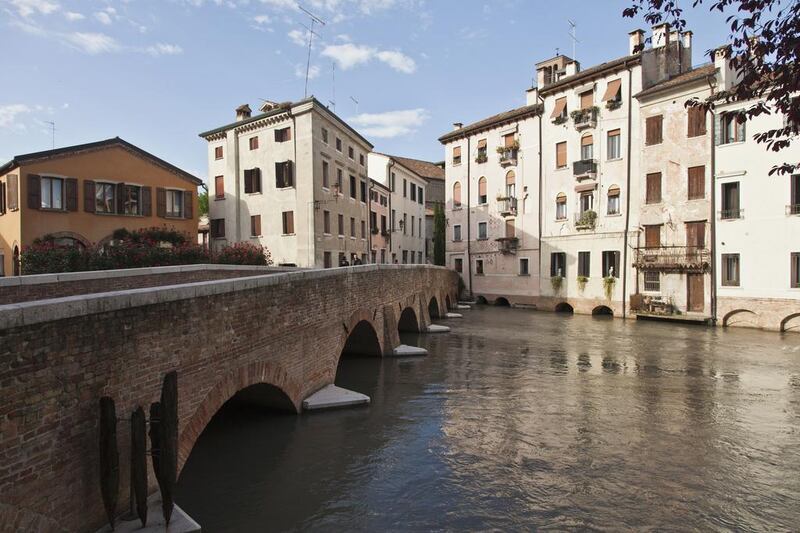 While many tourists use Treviso as a stop-off en route to Venice, it has many waterways of its own, plus portico-lined streets. Getty Images