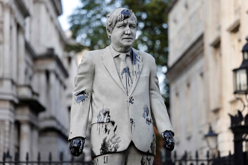 An oil-splattered, mock statue of British Prime Minister Boris Johnson by artist Hugo Farmer is installed by Greenpeace activists at Downing Street in London on Monday. AFP