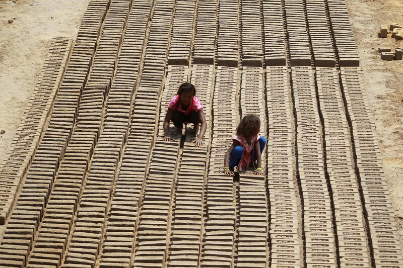 Indian children work at a brick factory on the outskirts of Jammu. Channi Anand / AP Photo