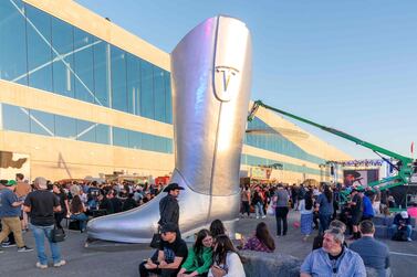 A giant cowboy boot is on display outside the Tesla Giga Texas manufacturing facility during the "Cyber Rodeo" grand opening party on April 7, 2022 in Austin, Texas.  - Tesla welcomed throngs of  electric car lovers to Texas on April 7 for a huge party inaugurating a "gigafactory" the size of 100 professional soccer fields.  (Photo by SUZANNE CORDEIRO  /  AFP)