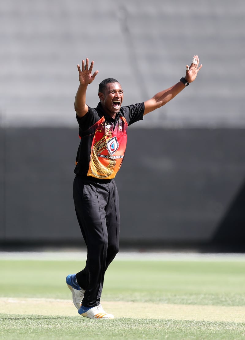 PNG's Alei Nao takes the wicket of UAE's Alishan Sharafu. Chris Whiteoak / The National
