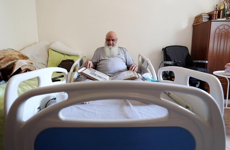 ABU DHABI,  UNITED ARAB EMIRATES , JUNE 17 – 2019 :- Mohammed Ishaq a player in the UAE's 1996 World Cup side, who is now wheelchair bound showing newspapers clipping at his home in Abu Dhabi. He is on wheelchair since a car crash in 2009. ( Pawan Singh / The National ) For Sport. Story by Paul