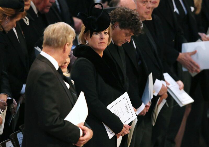 Carol Thatcher looks across at brother Mark as they attend the ceremonial funeral of his mother, British former prime minister Margaret Thatcher, in St Paul's Cathedral in central London on April 17, 2013. The funeral of Margaret Thatcher took place on April 17, with Queen Elizabeth II leading mourners from around the world in bidding farewell to one of Britain's most influential and divisive prime ministers.  AFP PHOTO / POOL / CHRISTOPHER FURLONG
 *** Local Caption ***  928631-01-08.jpg