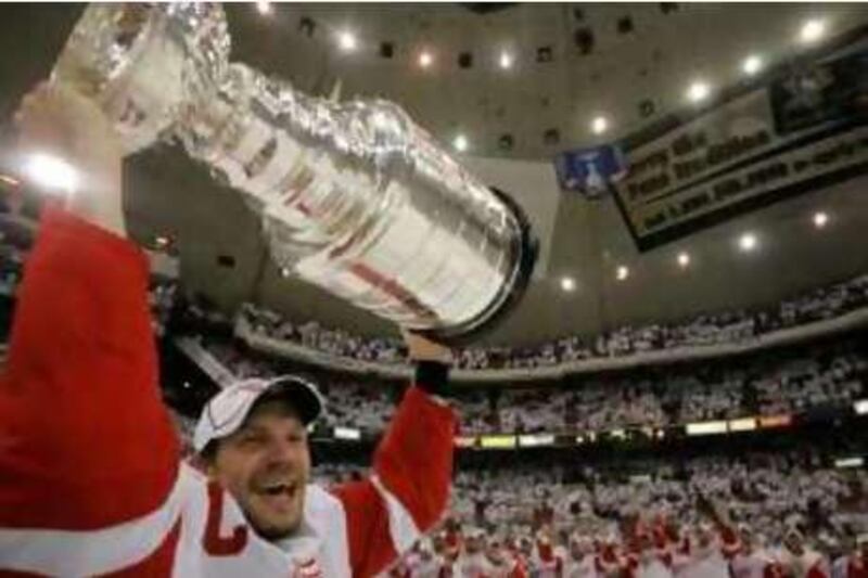 Detroit Red Wings defenseman Nicklas Lidstrom, of Sweden, holds the Stanley Cup after the Red Wings defeated the Pittsburgh Penguins 3-2 in Game 6 of the Stanley Cup NHL hockey finals in Pittsburgh, Wednesday, June 4, 2008. (AP Photo/Gene J. Puskar)