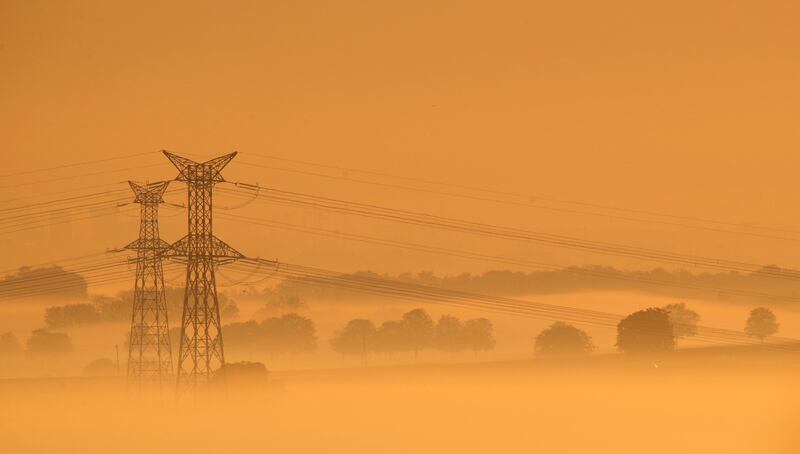 Pylons of high-tension electricity power lines are surrounded by autumn mist in the early morning light outside Breuschwichersheim, near Strasbourg, France. Christian Hartmann / Reuters