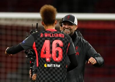 Liverpool's manager Jurgen Klopp, right, of Germany embraces Liverpool's Rhys Williams as they celebrate their victory following the group D Champions League soccer match between Ajax and Liverpool at the Johan Cruyff ArenA in Amsterdam, Netherlands, Wednesday, Oct. 21, 2020. Liverpool won the match 1-0. (AP Photo/Peter Dejong)