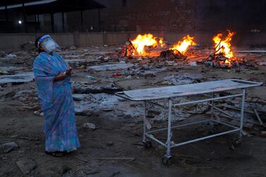 A woman cries during the cremation of her husband, who died of Covid-19, at a crematorium in New Delhi. Reuters