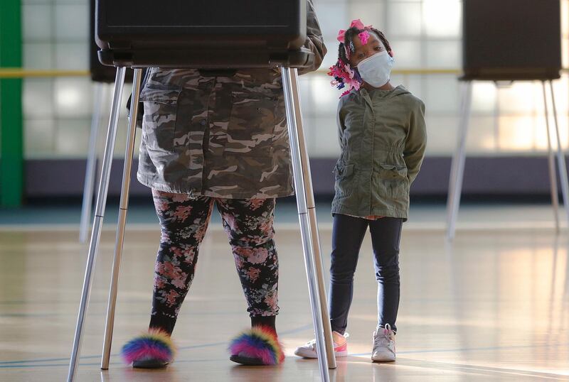 Karrihanna Stone, age 5, waits while her mother, Cashonda Davis casts her vote at a polling location at the Zelma Watson George Community Center in Cleveland Ohio.  EPA