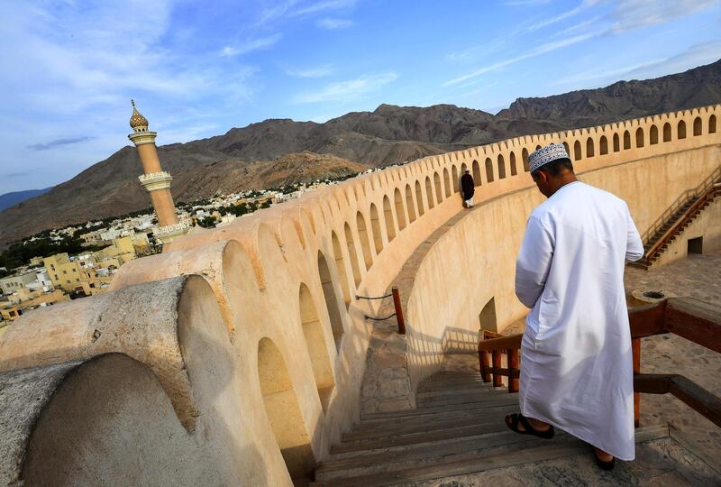 This picture taken on November 29, 2018 shows a man descending a staircase in the Nizwa Fort, a 17th-century fortification in the city of the same name, about 160 kilometres southwest of the capital Muscat.  / AFP / GIUSEPPE CACACE
