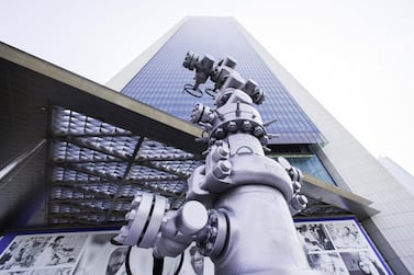 An oil pipeline control head sits on display outside the entrance to the Abu Dhabi National Oil Company (Adnoc) headquarters in Abu Dhabi. Photographer: Christopher Pike/Bloomberg