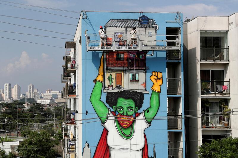 Brazilian artist Mundano works on a graffiti called "Heroinas Invisiveis" (invisible heroines), a tribute to the women during the outbreak of the coronavirus  at Heliopolis slum in Sao Paulo, Brazil. Reuters
