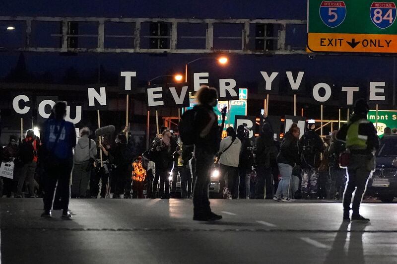 Protesters hold letters that spell Count Every Vote as they cross an overpass while marching in Portland, Oregon. AP Photo