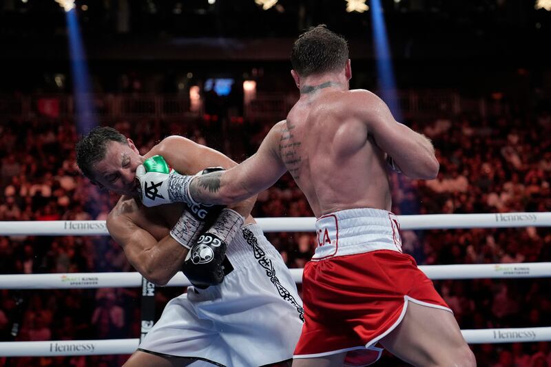 Canelo Alvarez lands a left hand on Gennady Golovkin in their super middleweight title fight. AP