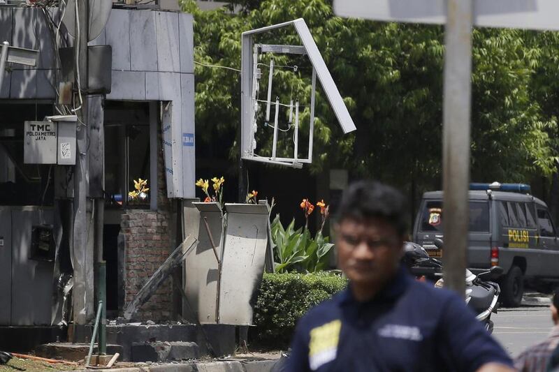 Indonesia Police make line near one of bomb blast locations. Achmad Ibrahim / AP Photo