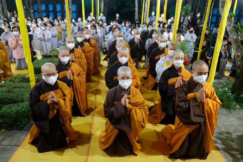 Monks and followers pray during the funeral. AP Photo