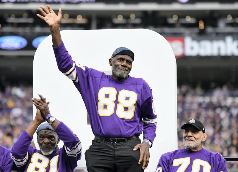 MINNEAPOLIS, MINNESOTA - SEPTEMBER 22: Hall of Fame player Alan Page acknowledges the crowd as former teammates Carl Eller and Jim Marshall look on as the Minnesota Vikings honor their 1969 team during halftime of the game against the Oakland Raiders at U.S. Bank Stadium on September 22, 2019 in Minneapolis, Minnesota.   Hannah Foslien/Getty Images/AFP