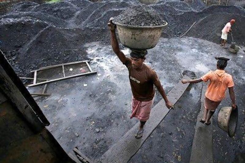 Workers load coal at a depot in Gauhati. India must stop building coal infrastructure and focus on renewable power generation to aid the global fight against climate change, according to UN chief Antonio Guterres. Anupam Nath / AP Photo