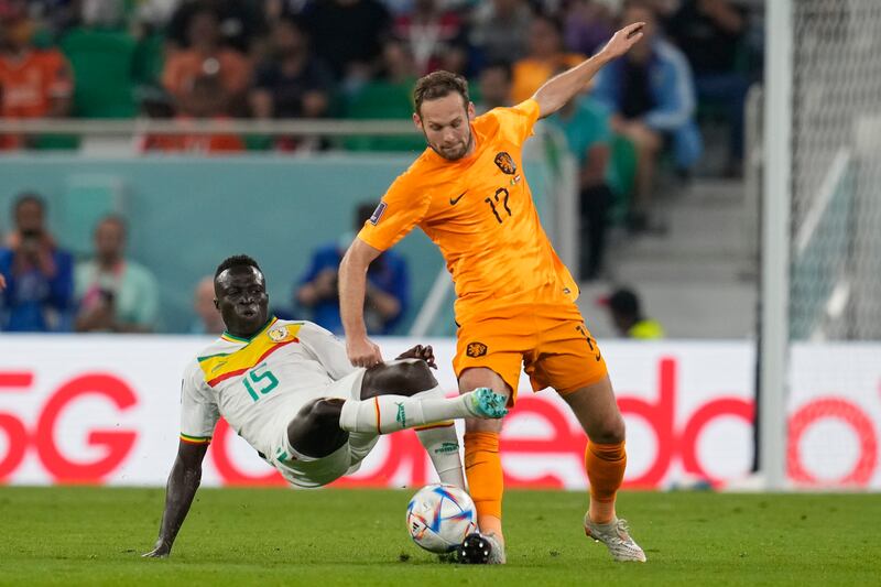 Daley Blind of the Netherlands, left, is challenged by Senegal's Krepin Diatta. AP 