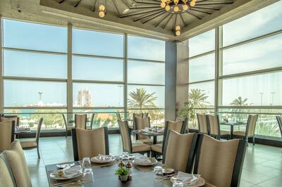 A glass-encased terrace offers glittering city and water views. Photo: Laung by Peppermill