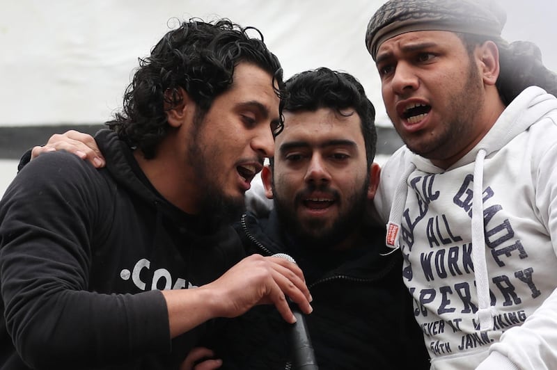 This picture taken on March 15, 2019, shows the late Syrian rebel fighter Abdel-Basset al-Sarout (L) singing during a rally to commemorate the beginning of the Syrian revoltion, in the town of Maaret al-Numan in the jihadist-held Idlib province. The Syrian goalkeeper turner rebel fighter who starred in an award-winning documentary died of his wounds today aged 27 after fighting regime forces in northwest Syria, a monitor and his faction said.
Al-Sarout was a goalkeeper from the central city of Homs, who became its most popular singer of protest songs after Syrian uprising broke out in March 2011. / AFP / OMAR HAJ KADOUR
