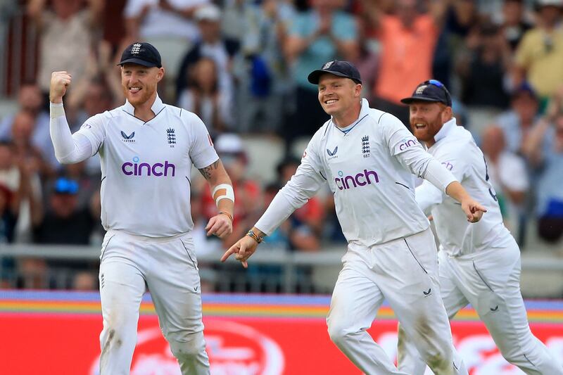 England's captain Ben Stokes, left, Ollie Pope and Jonny Bairstow, right, celebrate victory over South Africa in the second Test at Old Trafford. AFP