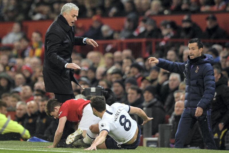 Manchester United's Welsh midfielder Daniel James (2nd L) collides with Tottenham Hotspur's Portuguese head coach Jose Mourinho (L) on the touchline after a challenge with Tottenham Hotspur's English midfielder Harry Winks (R) during the English Premier League football match between Manchester United and Tottenham Hotspur at Old Trafford in Manchester, north west England, on December 4, 2019. (Photo by Oli SCARFF / AFP) / RESTRICTED TO EDITORIAL USE. No use with unauthorized audio, video, data, fixture lists, club/league logos or 'live' services. Online in-match use limited to 120 images. An additional 40 images may be used in extra time. No video emulation. Social media in-match use limited to 120 images. An additional 40 images may be used in extra time. No use in betting publications, games or single club/league/player publications. / 