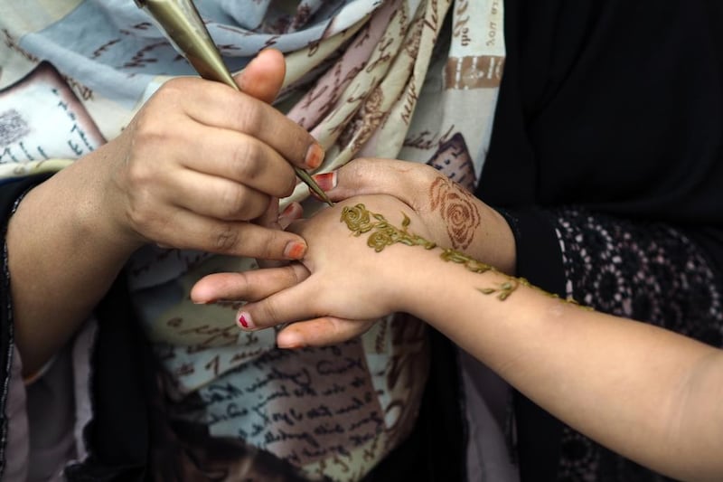 A woman has her hand painted with henna during Africa Day celebrations on Saturday. Delores Johnson / The National