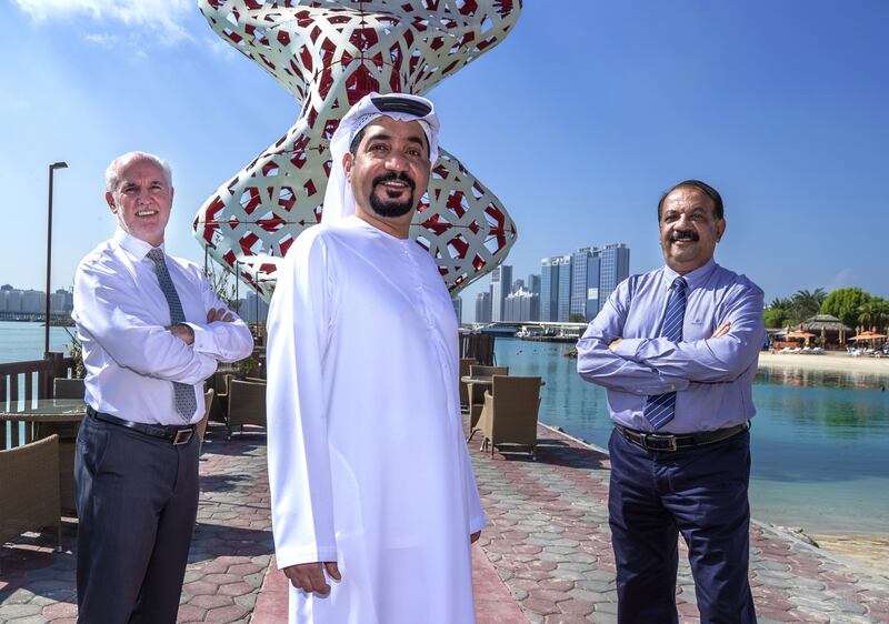 From left: Mike McGrath, departing general manager of The Club Abu Dhabi, Ali Kaddas, chairman, and K Thomas, who was financial controller at The Club for the past 35 years and also retired this year. Victor Besa / The National