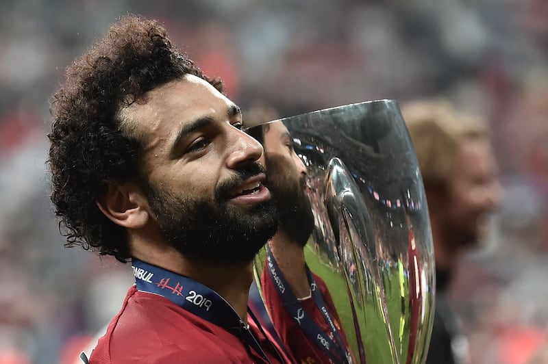 Liverpool's Egyptian midfielder Mohamed Salah poses with the trophy after Liverpool won the UEFA Super Cup 2019 football match between FC Liverpool and FC Chelsea at Besiktas Park Stadium in Istanbul on August 14, 2019.  / AFP / OZAN KOSE
