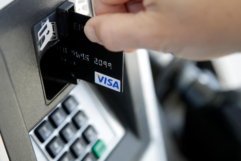 FILE - In this June 15, 2017, file photo, a customer inserts a credit card to buy gas in Haverhill, Mass. Itâ€™s always good to pay off your credit card debt, but now may be a better time than ever to do so. Americansâ€™ debt levels have been creeping back up recently and interest rates are expected to rise soon. Thatâ€™s a combination that could put consumers in a bind if theyâ€™re carrying a balance on their cards. (AP Photo/Elise Amendola, File)