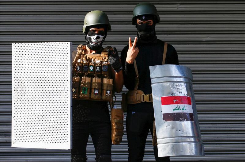 Iraqi demonstrators gesture. Reuters