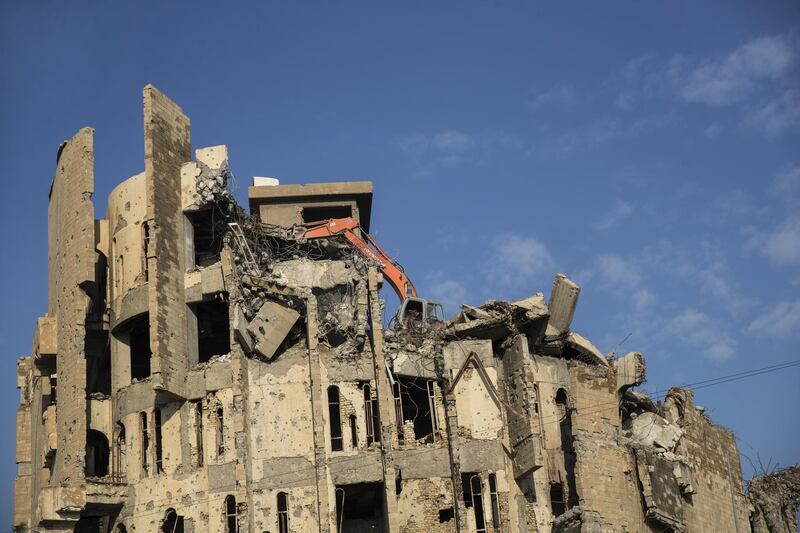 A crane demolishes a building in the Old City of Mosul, Iraq. Bloomberg