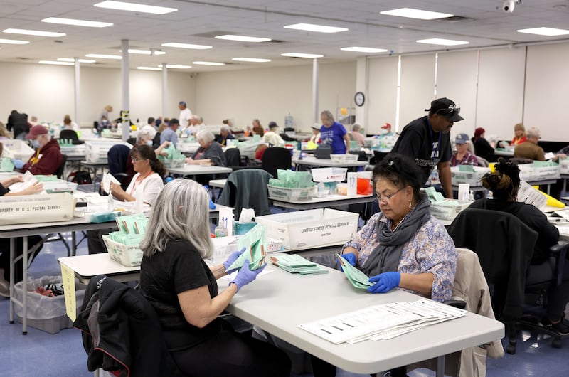 Election workers open mail-in ballots at the Maricopa County Tabulation and Election Centre in Phoenix, Arizona. AFP