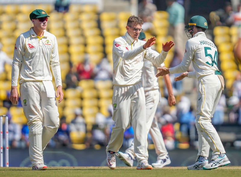 Australia's Todd Murphy, centre, picked up seven wickets on debut. AP