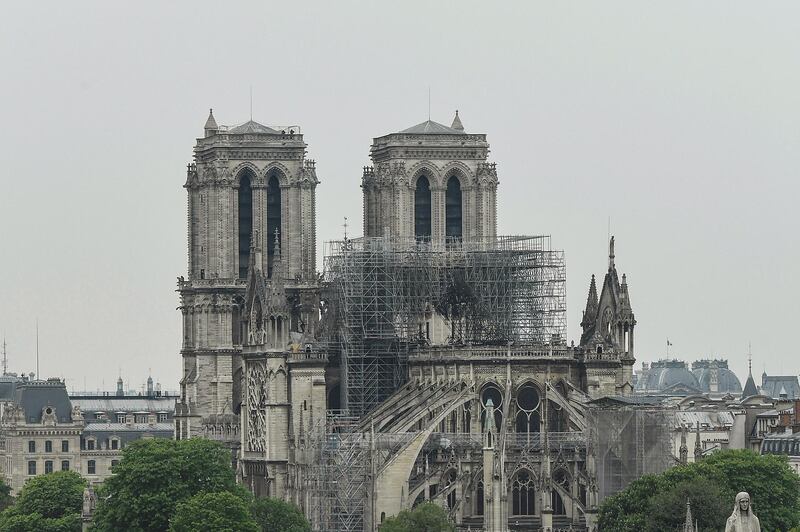 A picture taken on April 16, 2019 shows Notre-Dame-de-Paris in the aftermath of a fire that devastated the cathedral.  Paris was struck in its very heart as flames devoured the roof of Notre-Dame, on April 15, 2019, the medieval cathedral made famous by Victor Hugo, its two massive towers flanked with gargoyles instantly recognisable even by people who have never visited the city.  / AFP / BERTRAND GUAY
