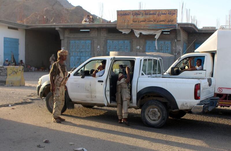 Yemeni troops search a vehicle at a checkpoint following an ISIL-claimed suicide attack at a naval base near the southern port city of Mukalla on May 12, 2016. AFP





