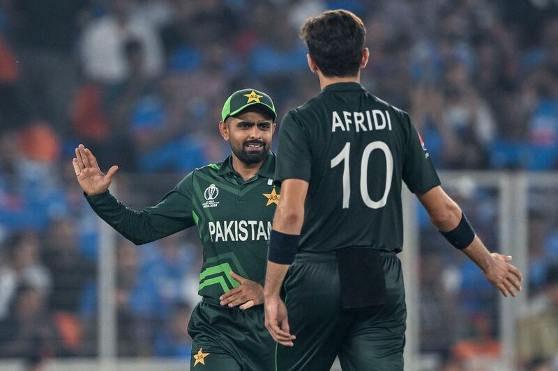 Pakistan's captain Babar Azam celebrates with Shaheen Afridi after the dismissal of India's captain Rohit Sharma. AFP