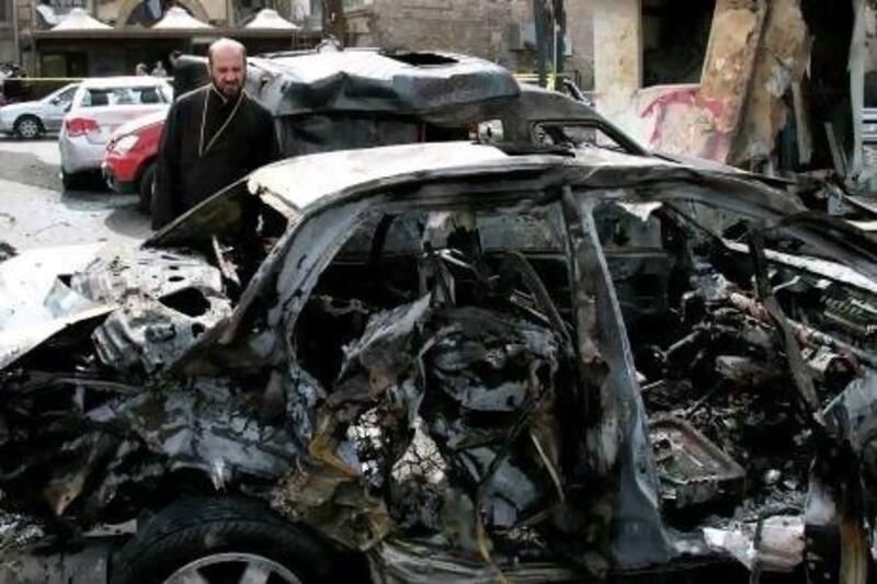 A Syrian man looks at a damaged car after a car bomb attack in Bab Touma neighborhood, a popular shopping district largely inhabited by Syria's Christian minority in Damascus.