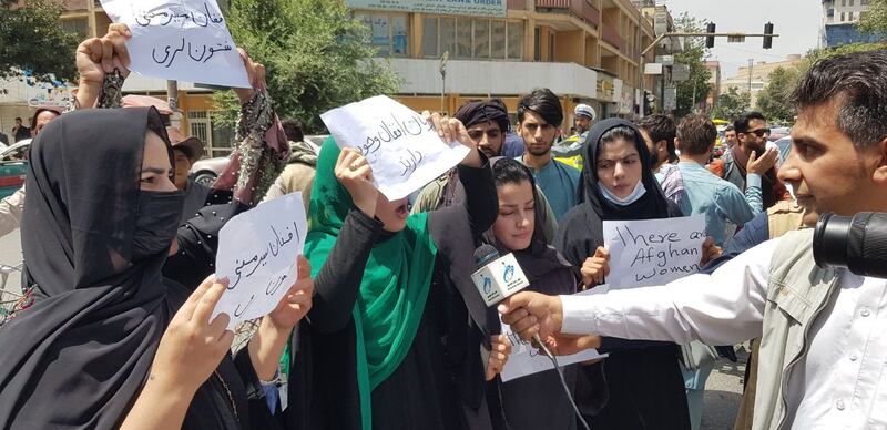 Afghan women, holding placards, gather to demand the protection of women's rights in front of the Presidential Palace in Kabul, on August 17, 2021. Getty Images