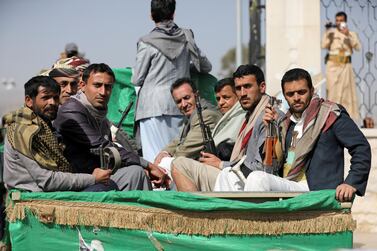 Armed Houthi followers ride on the back of a truck after attending the funerals of Houthi fighters killed in recent fighting against government forces in Marib, Yemen, on February 20, 2021. Reuters