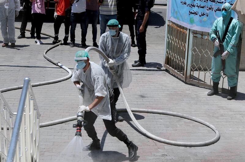 Gazan security forces spray disinfectant during a simulation exercise for preventing the spread of the coronavirus in the Palestinian territory. Reuters