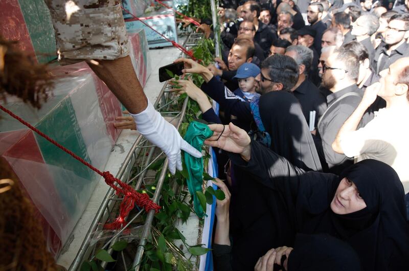 Iranians mourn during a funeral procession for 130 Iranian soldiers killed in the Iran-Iraq war (1980-1988), whose bodies were recently returned from Iraq, in Tehran, Iran. AFP