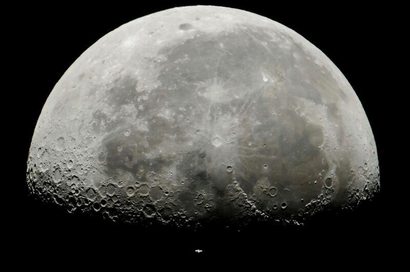 The International Space Station (centre, bottom of the image) passes in front of the Moon in its Earth orbit as photographed from Salgotarjan, Hungary. Peter Komka/EPA