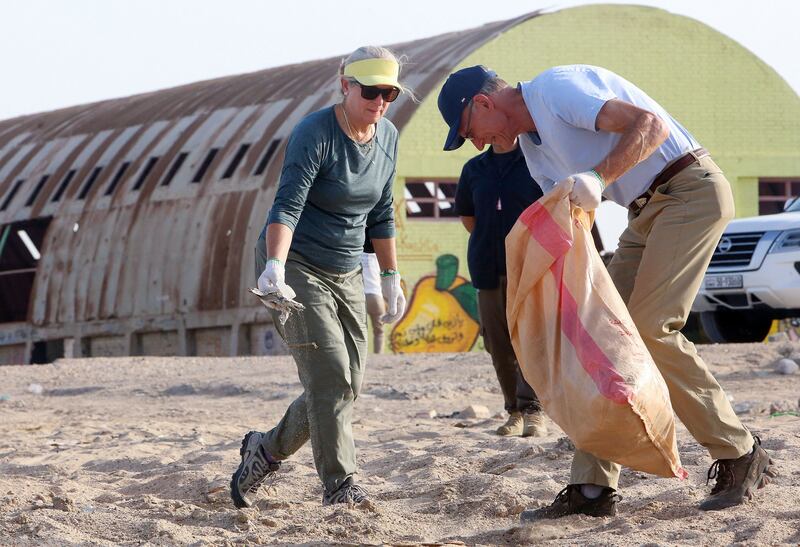 US Ambassador to Kuwait Alina L.  Romanowski (L) takes part in a clean-up campaign at Asheraj beach, 60Km north of Kuwait city, to mark World Clean Up Day, on September 18, 2021.  (Photo by Yasser Al-Zayyat  /  AFP)